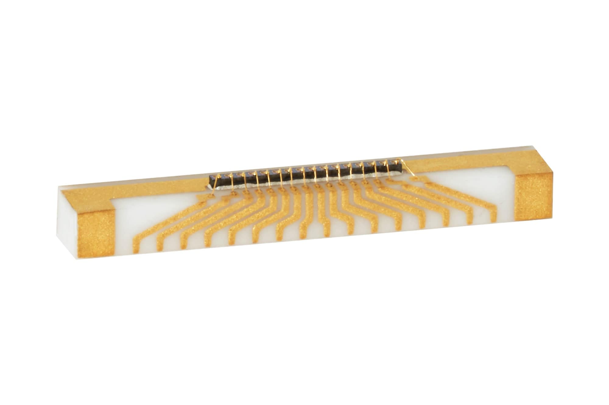 White ceramic bar with gold fan-out traces to a narrow die strip
