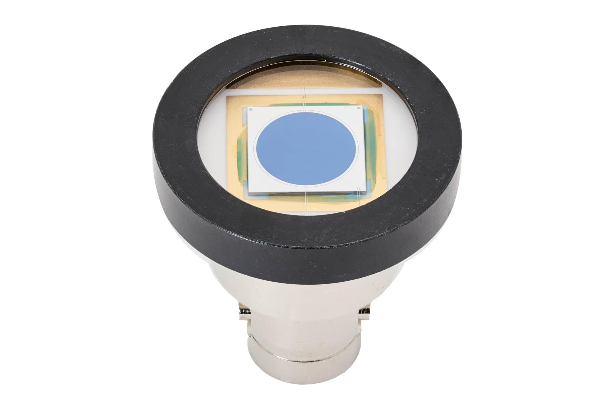 Black-ringed housing with a round die behind glass on a nickel connector base